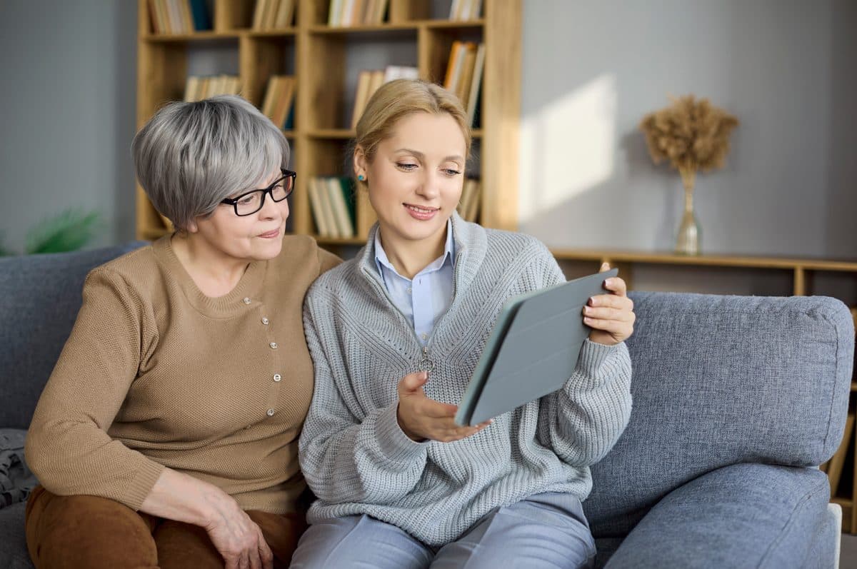 A health coach reviewing a care plan on a tablet with a patient